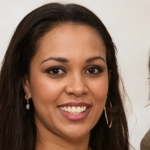 Joyful latino young-adult female with long  brown hair and brown eyes