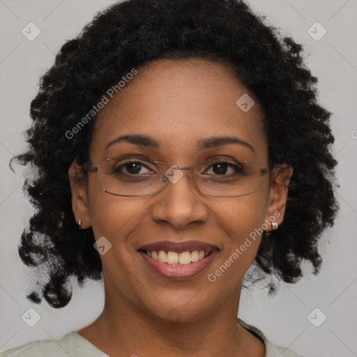 Joyful black adult female with short  brown hair and brown eyes