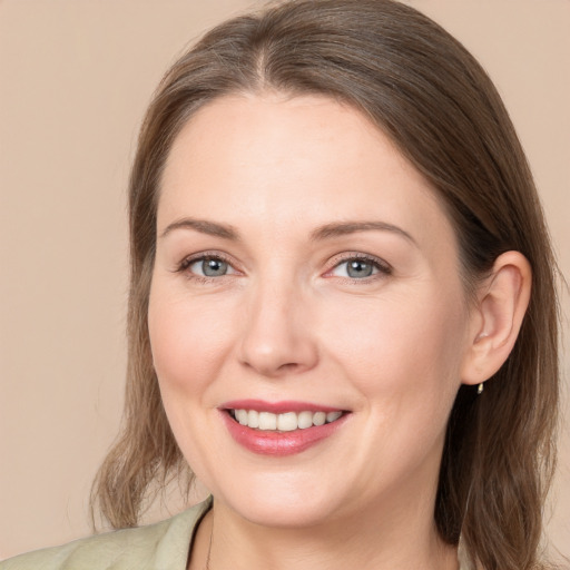 Joyful white young-adult female with medium  brown hair and grey eyes