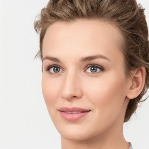 Joyful white young-adult female with medium  brown hair and green eyes