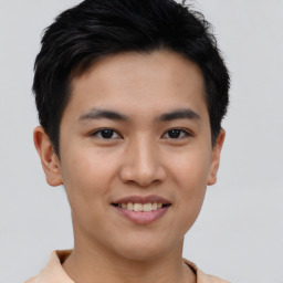 Joyful asian young-adult male with short  brown hair and brown eyes