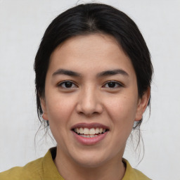 Joyful asian young-adult female with medium  brown hair and brown eyes