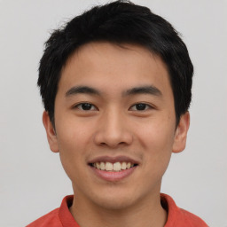 Joyful asian young-adult male with short  black hair and brown eyes