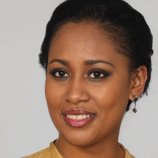Joyful black young-adult female with medium  black hair and brown eyes