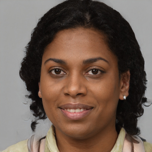 Joyful black young-adult female with medium  brown hair and brown eyes