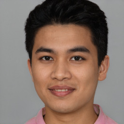 Joyful latino young-adult male with short  black hair and brown eyes