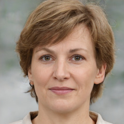 Joyful white adult female with medium  brown hair and grey eyes