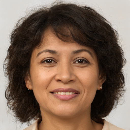 Joyful white adult female with medium  brown hair and brown eyes