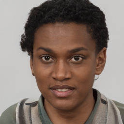 Joyful black young-adult male with short  brown hair and brown eyes