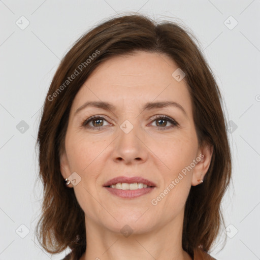 Joyful white adult female with medium  brown hair and brown eyes