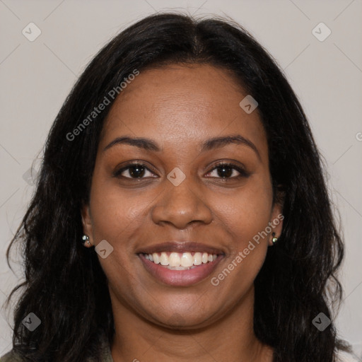 Joyful black young-adult female with long  brown hair and brown eyes