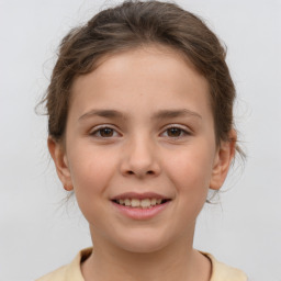 Joyful white child female with medium  brown hair and brown eyes