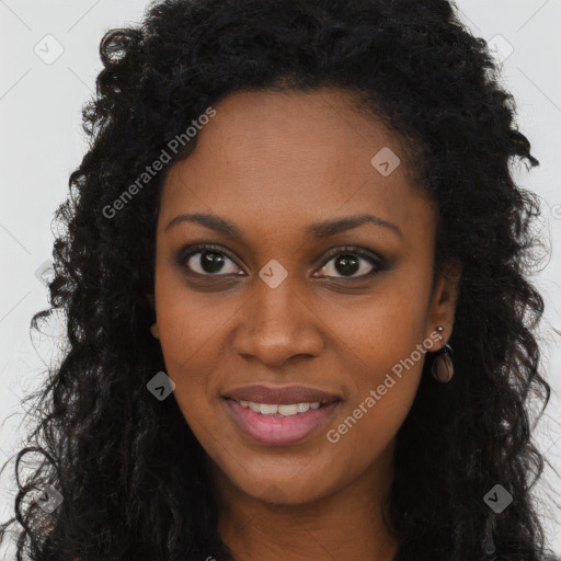 Joyful black young-adult female with long  brown hair and brown eyes