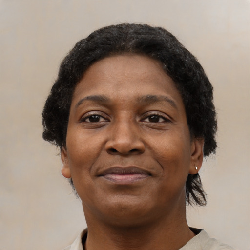 Joyful black adult female with short  brown hair and brown eyes