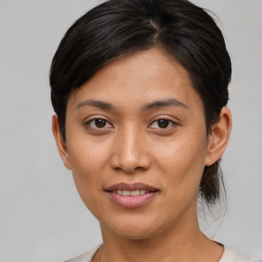 Joyful asian young-adult female with short  brown hair and brown eyes