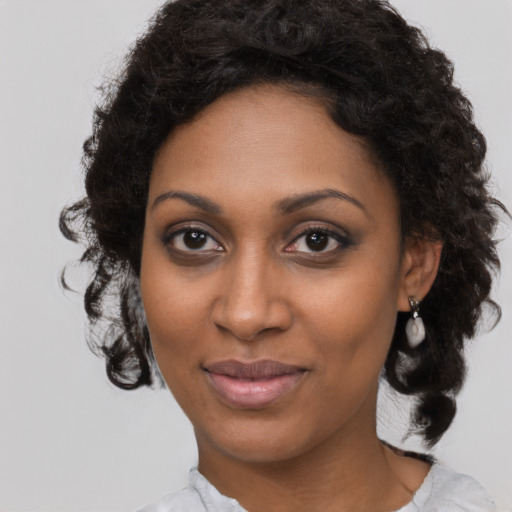 Joyful black young-adult female with medium  brown hair and brown eyes