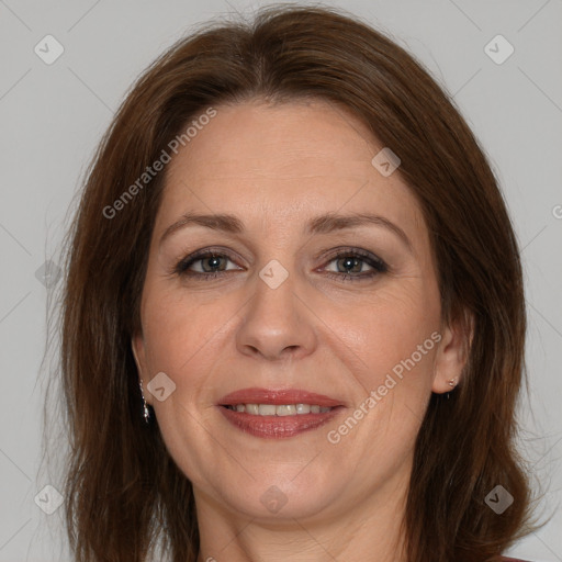 Joyful white adult female with long  brown hair and brown eyes