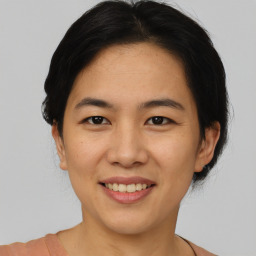 Joyful asian young-adult female with short  brown hair and brown eyes