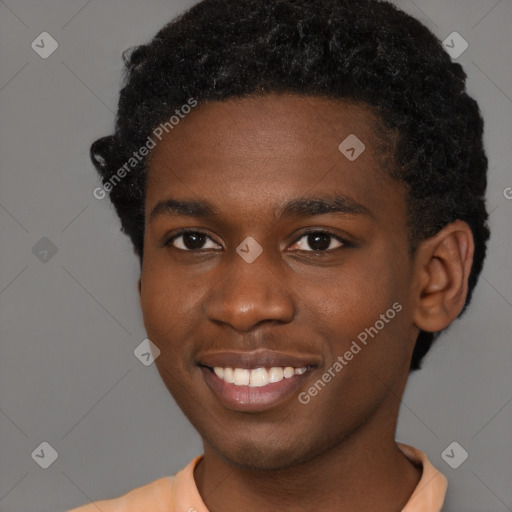 Joyful black young-adult male with short  brown hair and brown eyes