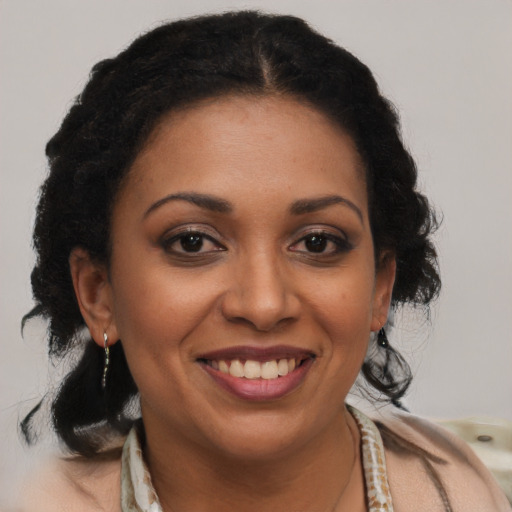 Joyful latino adult female with medium  brown hair and brown eyes