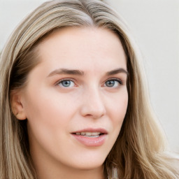 Joyful white young-adult female with long  brown hair and blue eyes