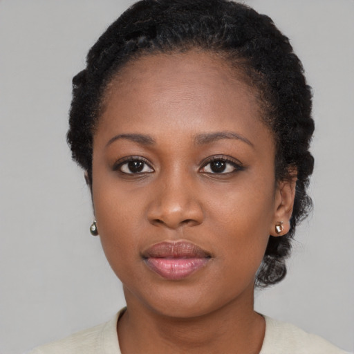 Joyful black young-adult female with short  black hair and brown eyes