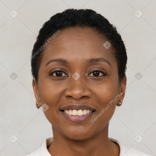 Joyful black young-adult female with short  black hair and brown eyes