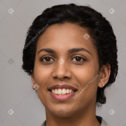 Joyful latino young-adult female with short  black hair and brown eyes