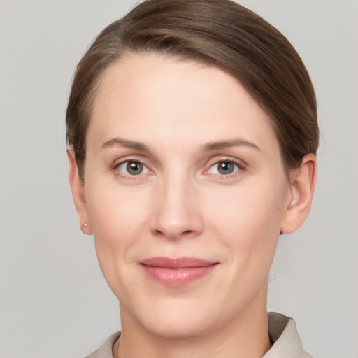 Joyful white young-adult female with short  brown hair and grey eyes