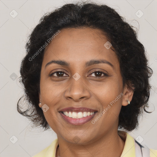 Joyful black adult female with long  brown hair and brown eyes