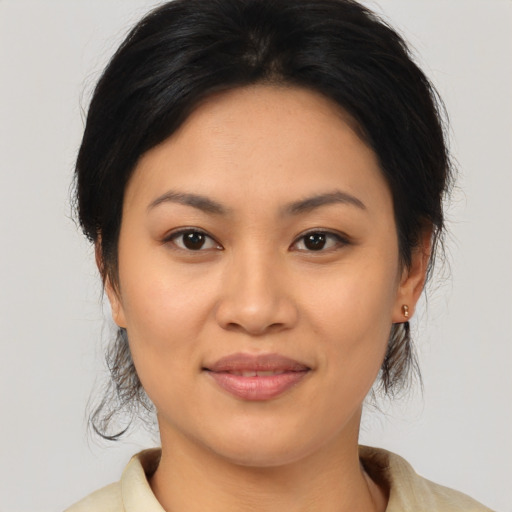 Joyful asian young-adult female with medium  brown hair and brown eyes