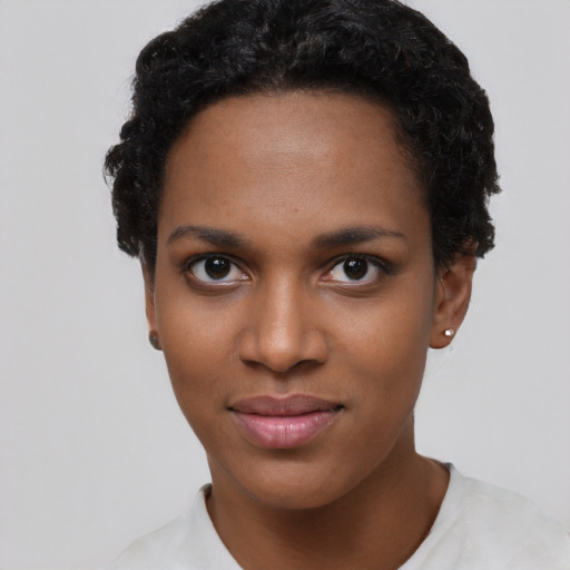 Joyful black young-adult female with short  black hair and brown eyes