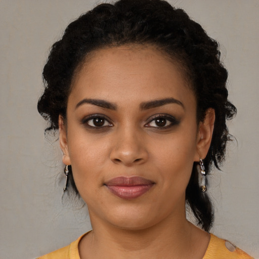 Joyful latino young-adult female with medium  black hair and brown eyes