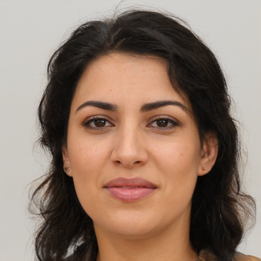 Joyful latino young-adult female with medium  brown hair and brown eyes