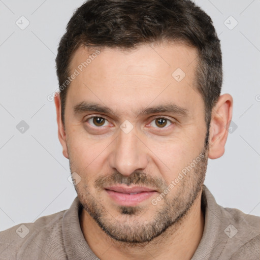 Joyful white adult male with short  brown hair and brown eyes