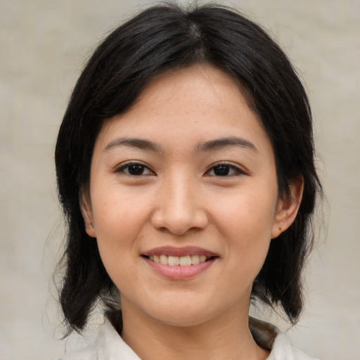 Joyful asian young-adult female with medium  brown hair and brown eyes