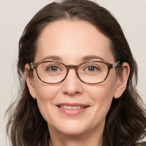 Joyful white adult female with long  brown hair and grey eyes