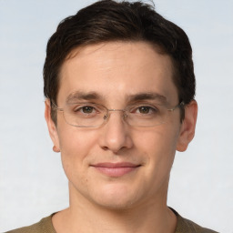 Joyful white adult male with short  brown hair and grey eyes