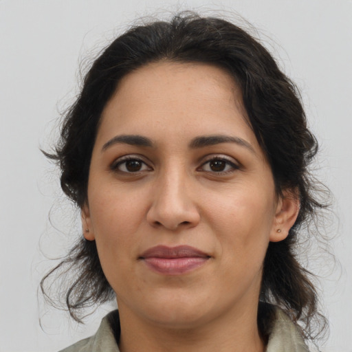Joyful latino young-adult female with medium  brown hair and brown eyes