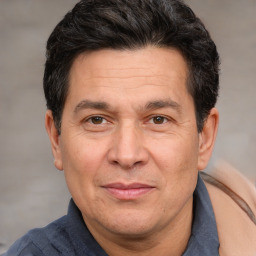 Joyful white adult male with short  black hair and brown eyes