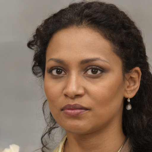 Neutral black young-adult female with long  brown hair and brown eyes