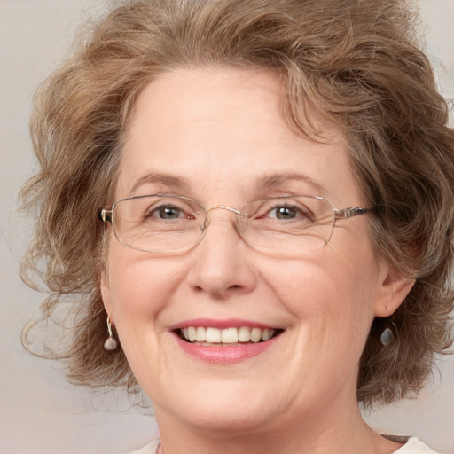 Joyful white middle-aged female with medium  brown hair and grey eyes