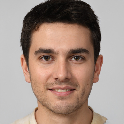 Joyful white young-adult male with short  brown hair and brown eyes