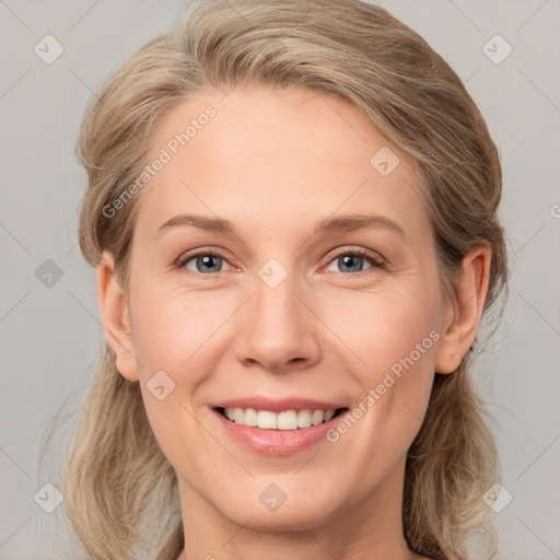 Joyful white young-adult female with medium  brown hair and blue eyes