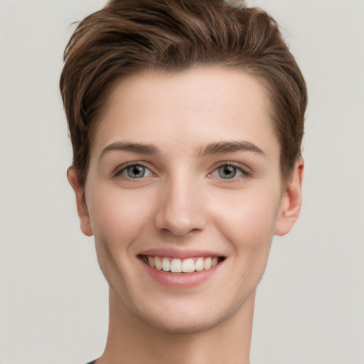 Joyful white young-adult female with short  brown hair and grey eyes