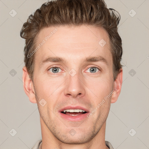 Joyful white adult male with short  brown hair and grey eyes