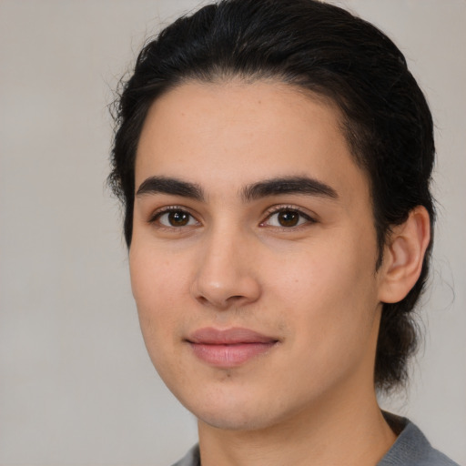 Joyful white young-adult male with medium  black hair and brown eyes