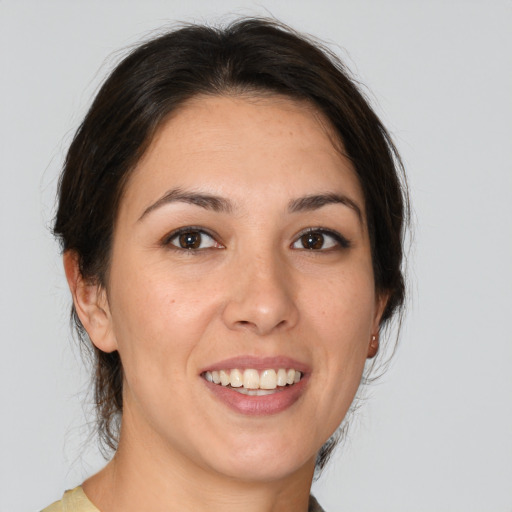 Joyful white young-adult female with medium  brown hair and brown eyes