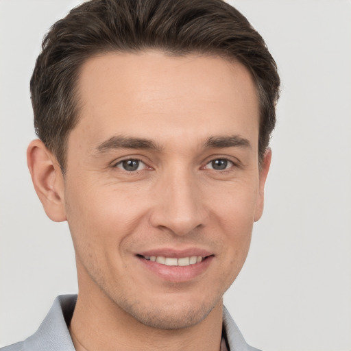 Joyful white young-adult male with short  brown hair and brown eyes