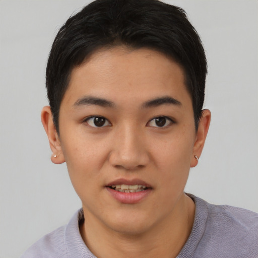 Joyful asian young-adult female with short  black hair and brown eyes